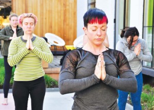 Lauren Recchia (front), marketing director of The Verb Hotel, taking a Rock n’ Roll Yoga class poolside last week. The Verb in the Fenway is hosting the classes all summer long with Instructor Chrissy Voccaro.